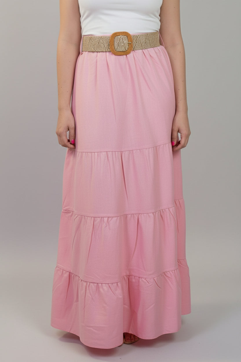 Person wearing a pink tiered skirt with a white background