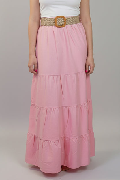 Person wearing a pink tiered skirt with a white background